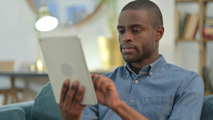 Young African Man using Digital Tablet 