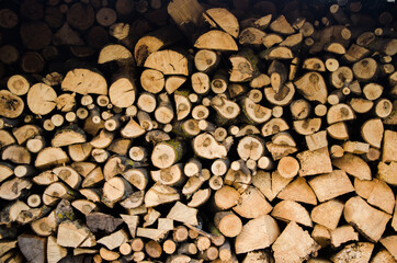 Stacked firewood close-up. Firewood storage close up. Stocks of wooden logs close-up. Chopping wood. 