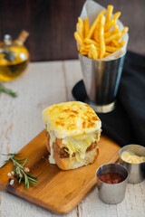 Seabass Burger with chips on wooden board