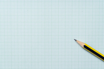 pencils on green graph paper, study research science and education concept