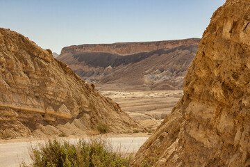The highway runs among the sandy mountains in the Judean Desert in Israel.