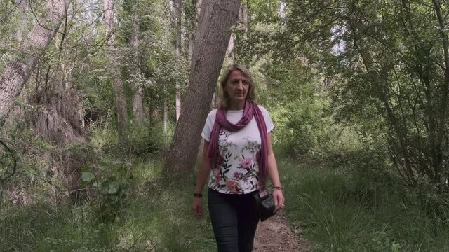 a girl walks through the forest