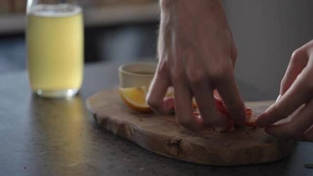 Man serve crab leg with pesto sauce with ginger beer on background
