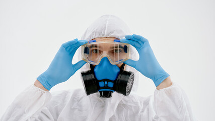 professional disinfector, looking at you through safety glasses.