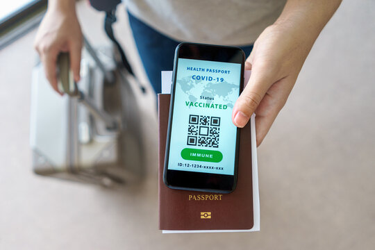 Health Passport Certification App, Tourist Uses Of Application On A Smartphone To Show Certify Vaccinated Status Of Coronavirus Covid-19 In Digital Heath Passport App At Airport With Citizen Passport