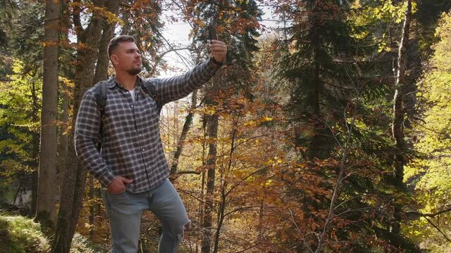 hiker is taking selfie in forest