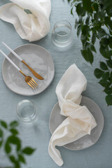 white linen napkin and light blue tablecloth