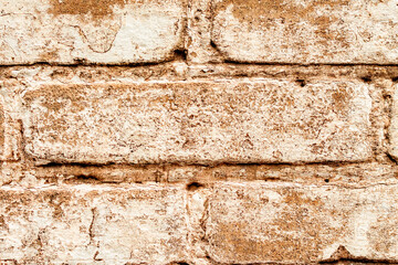 Texture of a brick wall with cracks and scratches which can be used as a background