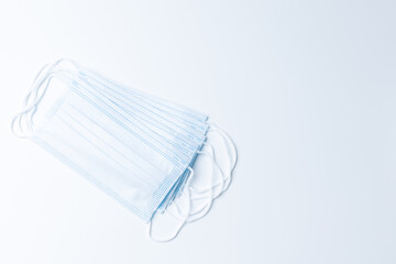 Top view blue medical mask on white background with copy space. For protection coronavirus people wearing mask every time, and social distancing.