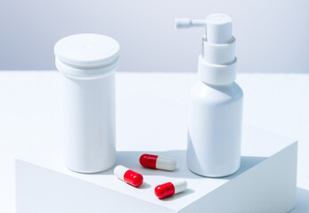 Pills and nasal spray, medicine from virus infections. White tubes of medicine products without a label for advertisement or blogger advice.