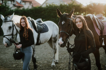 Obraz premium Beautiful young women enjoying with their horses..