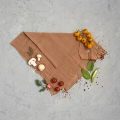 Crafted server napkin with vegetables - mushrooms, cherry tomatoes, basilic and spices on gray...
