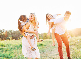 child family outdoor mother woman father girl happy happiness lifestyle having fun bonding piggyback