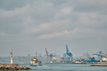 04.03.2021.istanbul, Turkey. Overcast and rainy day in istanbul bosphorus and transportation ship and pedestrian ferry and istanbul city and haydarpasa harbor and cranes background.