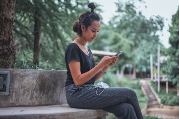 Fototapeta premium Young women using smart phone with warm smiling