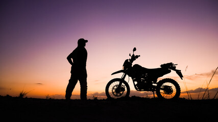 Silhouette of tourists adventuring with motorcycles, dirt bikes or motocross in the evenings. ....