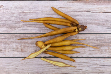 Fingerroot on wooden floor background.