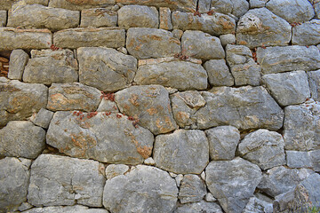 The stone masonry of the protective wall of the ancient city.