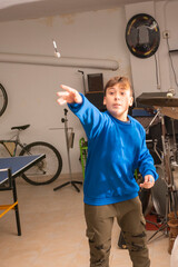 Teenager playing darts at home.