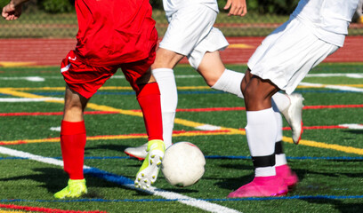High school soccer players fighting for possession of the ball
