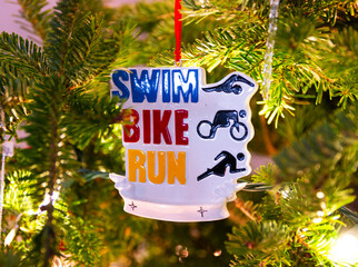 Triathlete Christmas ornament hanging on the tree