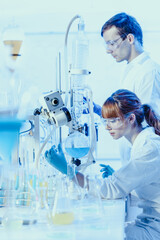 Young chemists researching in life science laboratory.