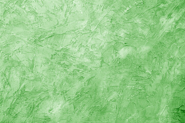 Texture of green plaster. Rough wall of the building.