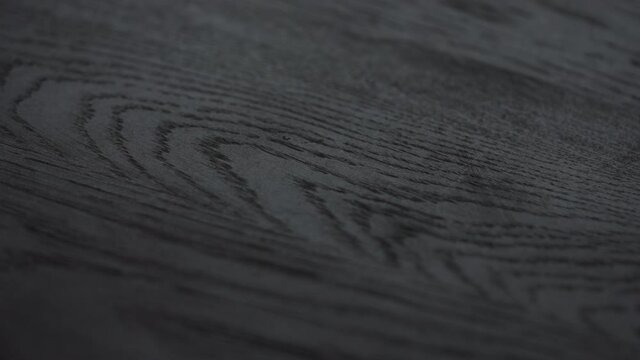 Slow motion shot of black oak wood surface