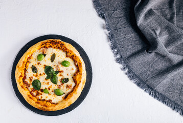 Traditional Margherita Pizza with basil, tomato, olive oil, mozzarella on a rustic background