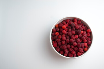 A close-up shot of a fresh raspberry in a white cup - perfect for a culinary blog diet and the benefits of natural vitamins. Healthy lifestyle. There is a place for your inscription.