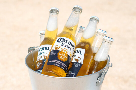 GENICHESK, UKRAINE - 19 June 2021: Illustrative editorial of chilled Corona beer bottles in a bucket on the beach.