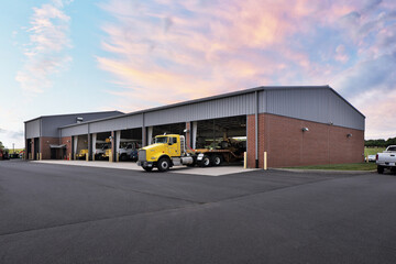 Brick garage parking building with yellow semi trucks