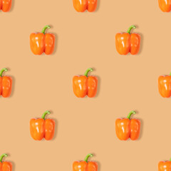 Orange pepper seamless pattern on orange background. Vegetable pattern for design. Abstract food background.