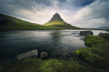 Low-angle view of Kirkjufell mountain against dramatic cloudy sky, Iceland, Sn&aelig;fellsnes peninsula