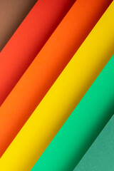 Colored bright background from folded paper material. Top view, flat lay