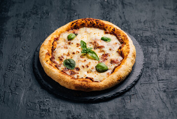 Traditional Margherita Pizza with basil, tomato, olive oil, mozzarella on a rustic background