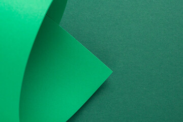Design background curved background from green cardboard. Top view, flat lay