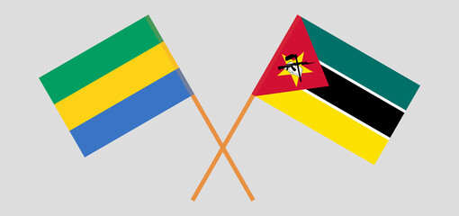 Crossed flags of Gabon and Mozambique. Official colors. Correct proportion