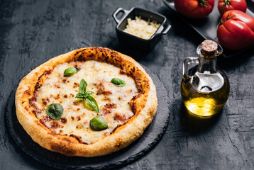 Traditional Margherita Pizza with basil, tomato, olive oil, mozzarella on a rustic background