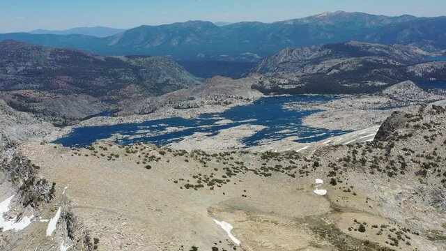 A tranquil lake is found in the Desolation Wilderness nestled high in the Sierra Nevada Mountains of California. This gorgeous, elevated landscape is a federally protected wilderness area.