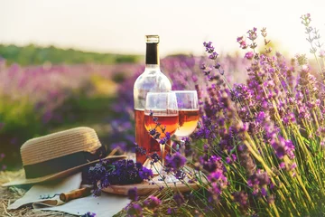 Deurstickers Wine in glasses. Picnic in the lavender field. Selective focus. © yanadjan