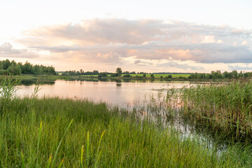 sunset on a beautiful lake, leaden clouds with a pink tint