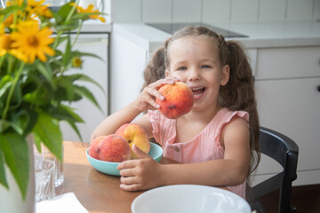 Happy little girl with peaches, a child sits at a table in a cafe, delicious fruits in a plate, yellow flowers in a vase.
