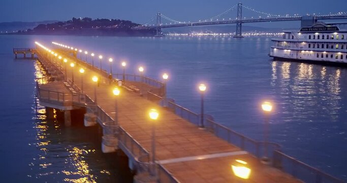 Aerial: Pier 7 & Bay Bridge. San Francisco Embarcadero at night. California, USA