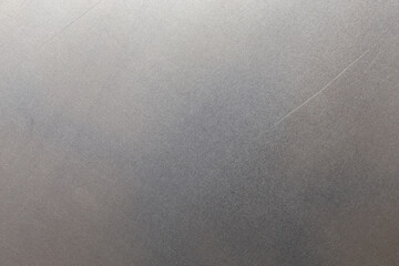 Uncoated flat cold rolled steel sheet surface with few minor scratches. Close-up in directly above...