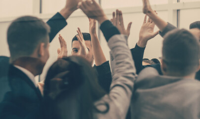 business team giving each other high five in new office.