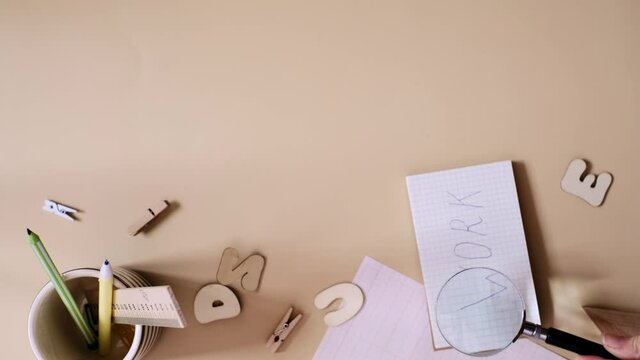 Work search concept.Top view of woman reads letters. Job in a notebook with magnifying glass in the notebook. Vertical video frame 9x16