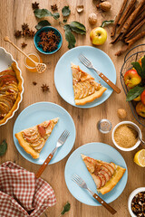 Thanksgiving autumn apple pie with fresh fruits and walnuts on wooden table, top view