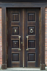Old brass handle on vintage wood door - 445790586