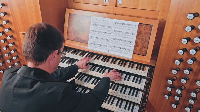 Organist plays music on church organ